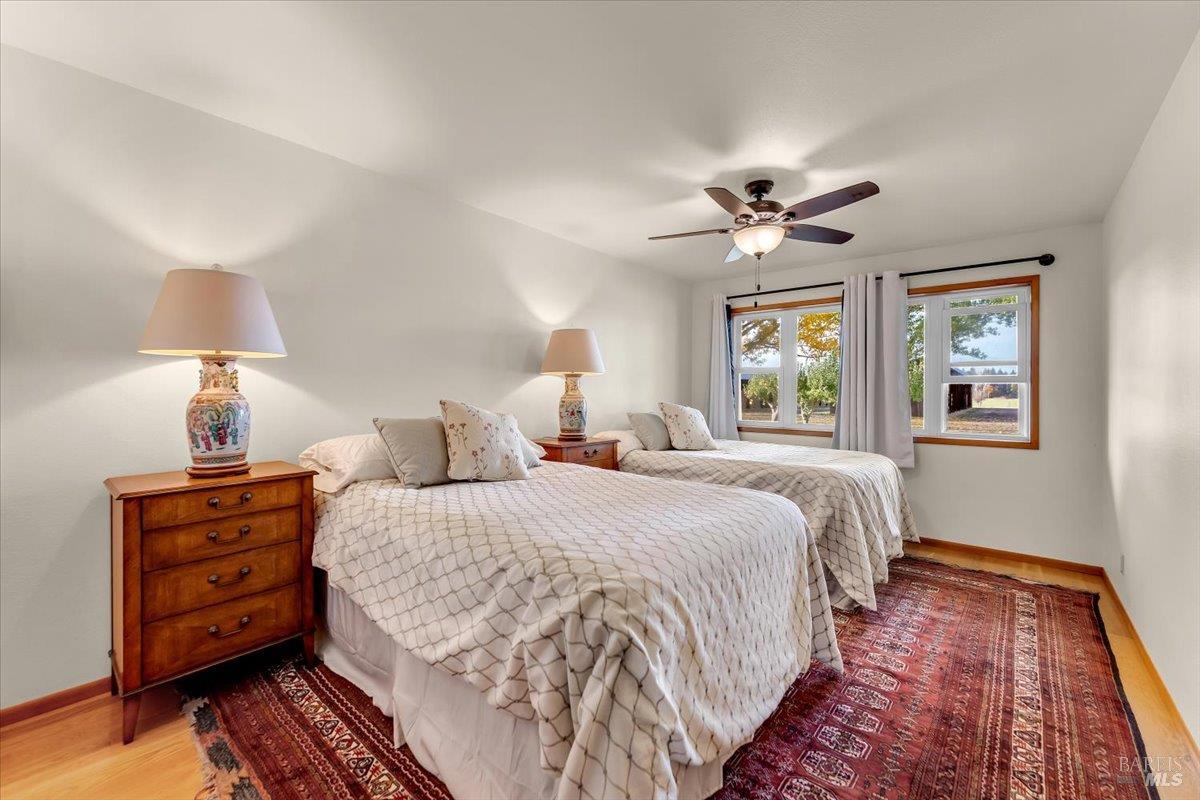 41579 Osprey Road Fall River Mills, CA 96028 - Photo 23 of 67 a bedroom with bed dresser and a chandelier
