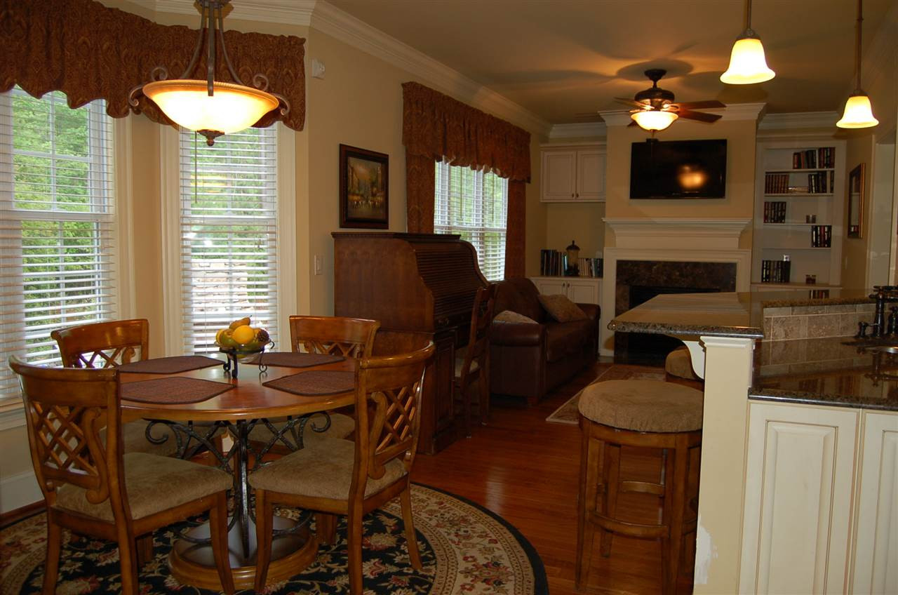 8111 Henderson Road Apex, NC 27539 - Photo 12 of 25 Breakfast area open to den with yet another gas log fireplace and custom built ins Breakfast Area