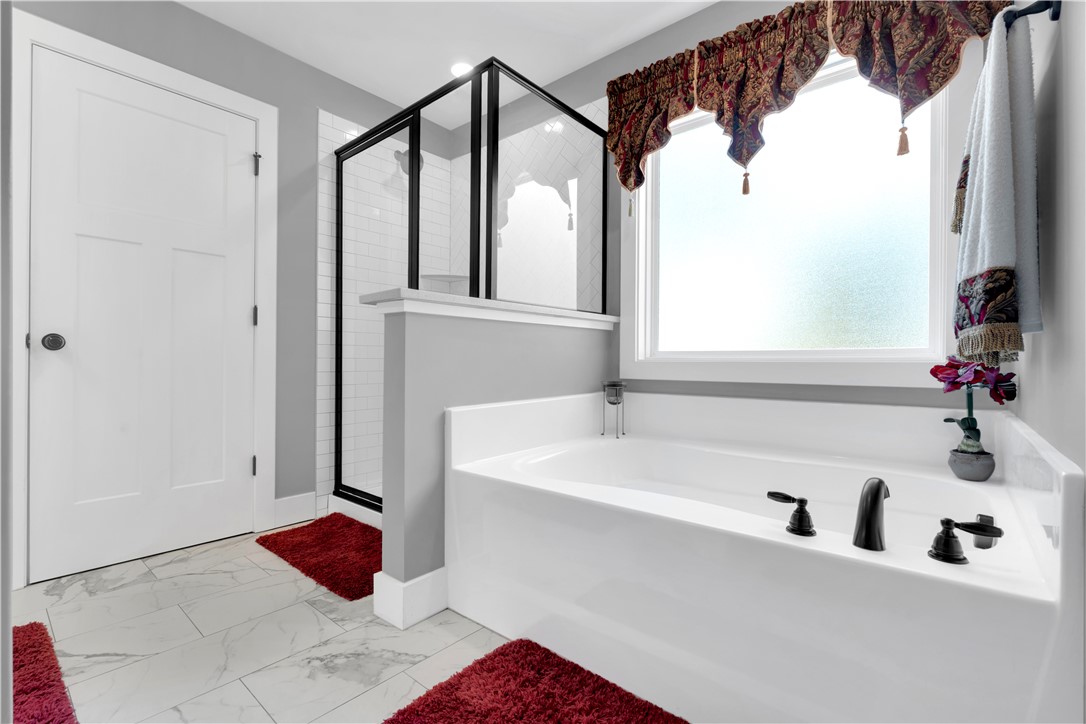 181 Amberwood Drive Anderson, SC 29621 - Photo 18 of 28 This serene bath features a deep soaking tub and a spacious shower, creating a tranquil oasis.