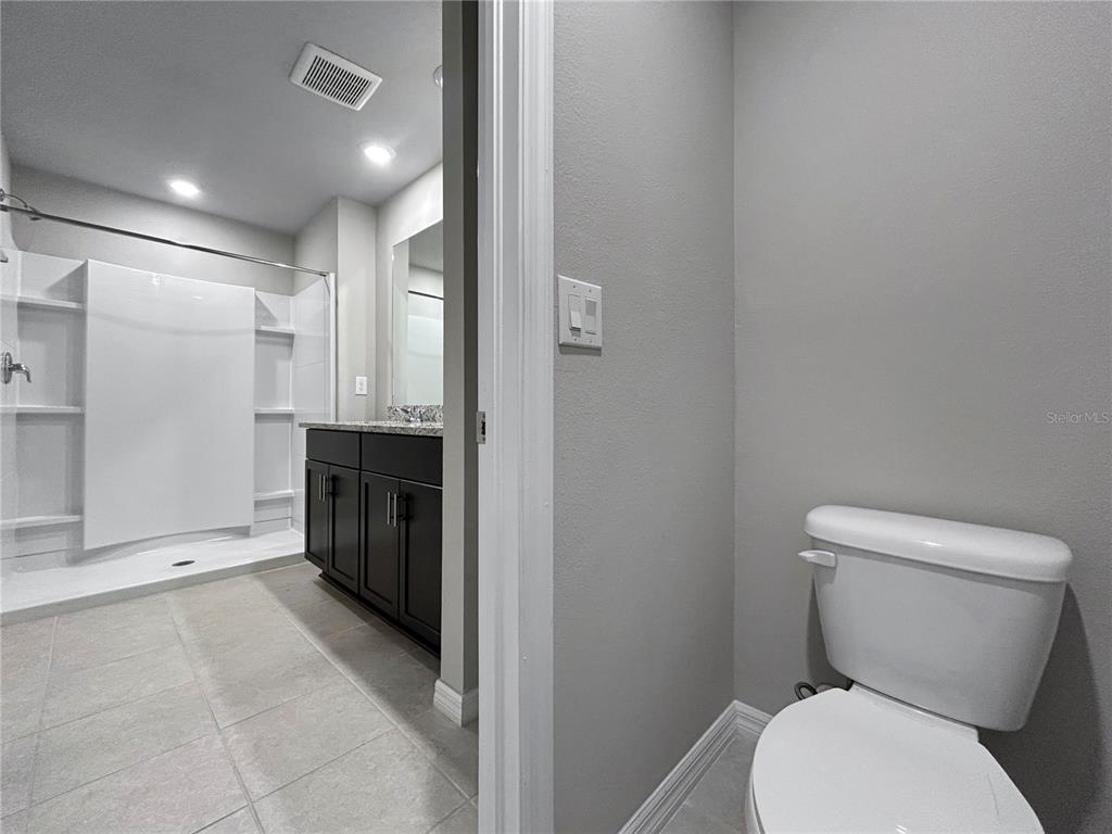 2764 Emory Sound Place Brandon, FL 33510 - Photo 34 of 43 a bathroom with a toilet a sink and mirror