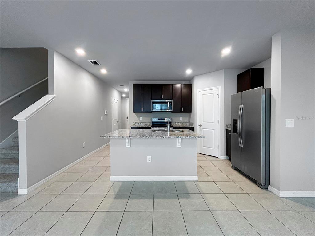 2764 Emory Sound Place Brandon, FL 33510 - Photo 7 of 43 a view of kitchen with refrigerator microwave and cabinets