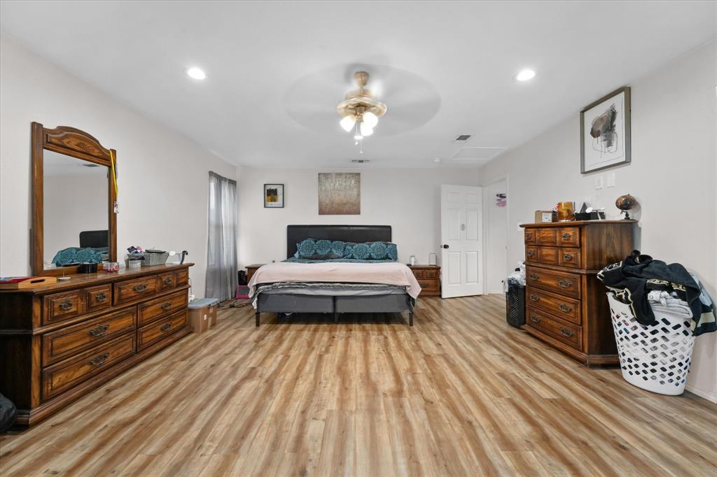6725 Prairie Fire Road Arlington, TX 76002 - Photo 15 of 31 a bedroom with a bed and a dresser