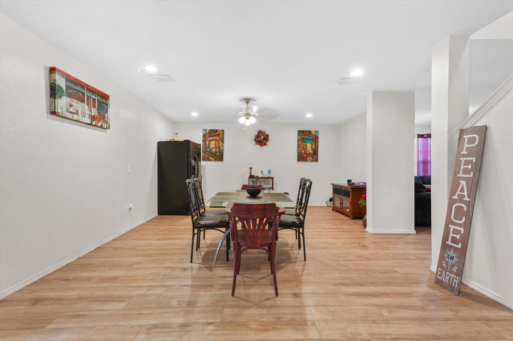 6725 Prairie Fire Road Arlington, TX 76002 - Photo 10 of 31 a dining room with furniture a rug and wooden floor