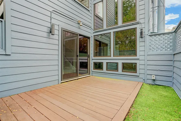 a view of a backyard with a large window and wooden fence