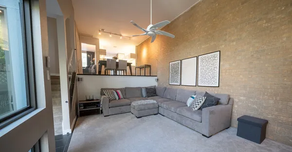 a living room with furniture and a mirror