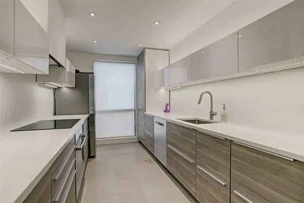 a kitchen with sink cabinets and stainless steel appliances