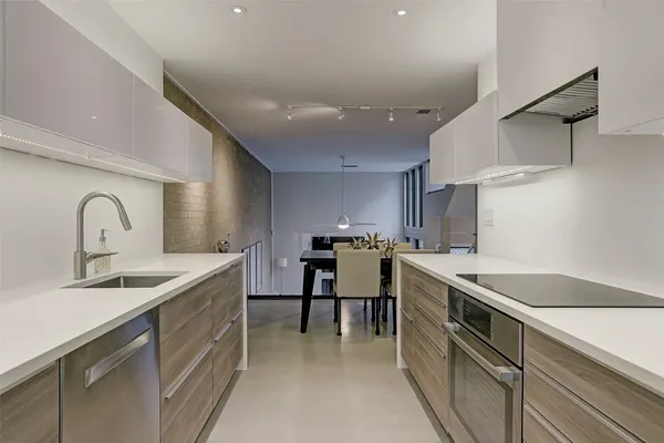 a kitchen with stainless steel appliances granite countertop sink stove and cabinets
