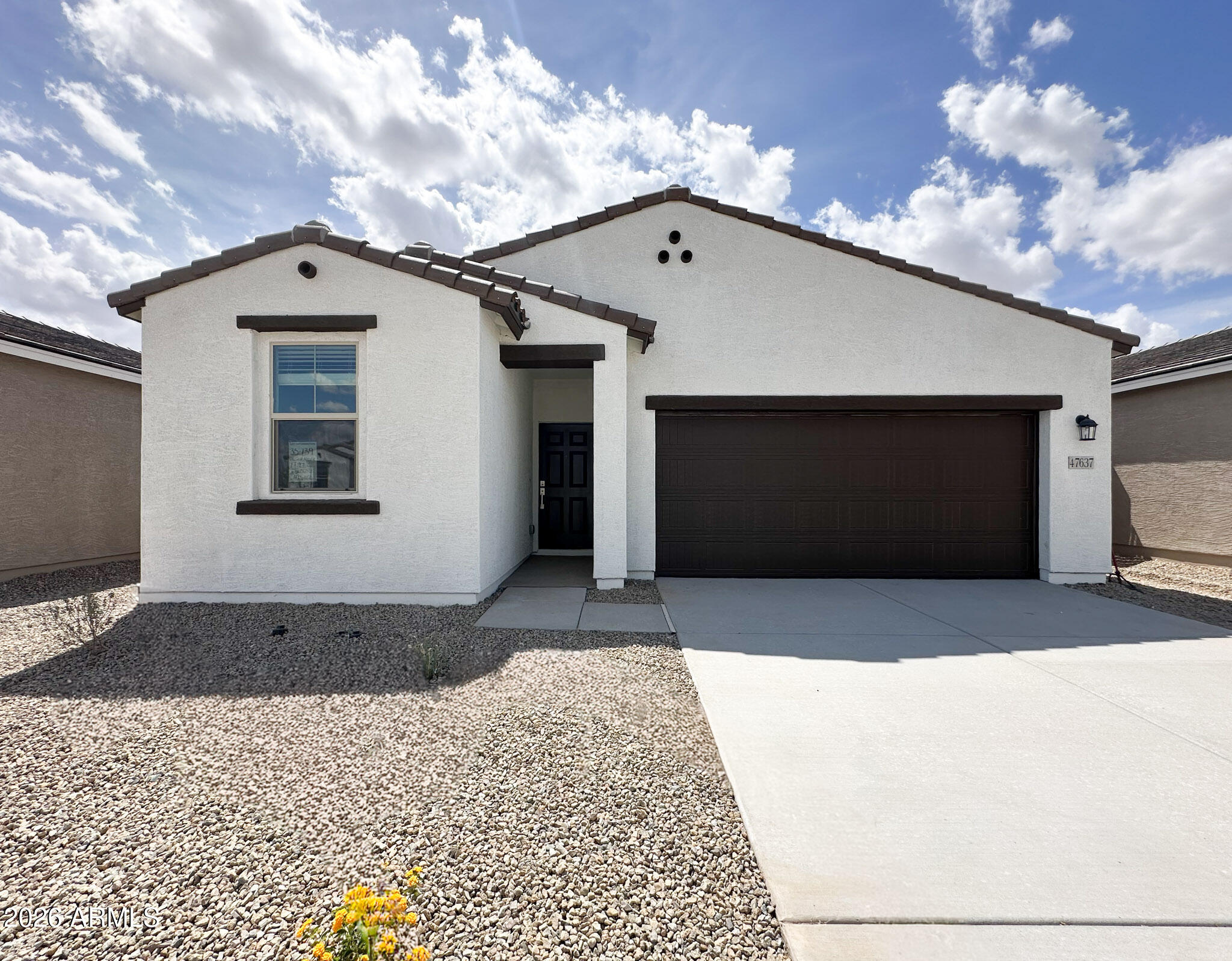 47637 West Moeller Road Maricopa, AZ 85139 - Photo 2 of 19 a front view of a house with a yard and garage