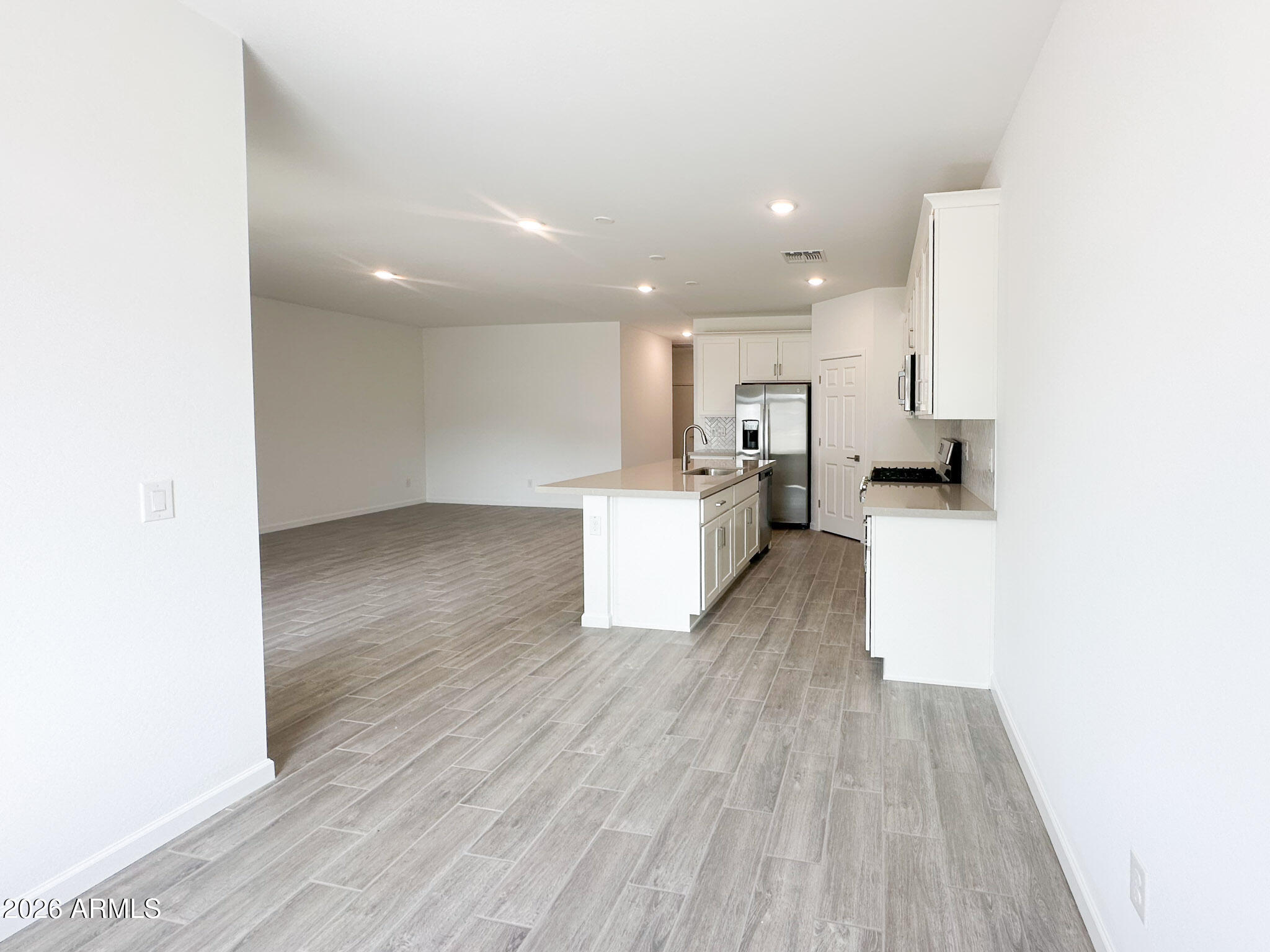 47637 West Moeller Road Maricopa, AZ 85139 - Photo 5 of 19 a view of a kitchen with wooden floor