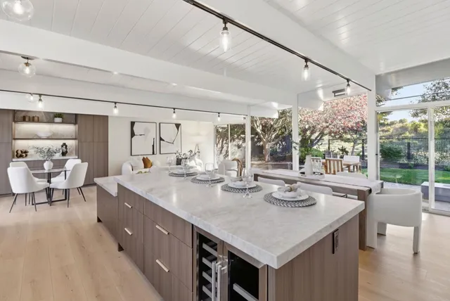 a open kitchen with stainless steel appliances granite countertop a lot of counter space and living room