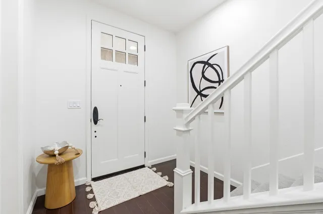 a view of an entryway with wooden floor