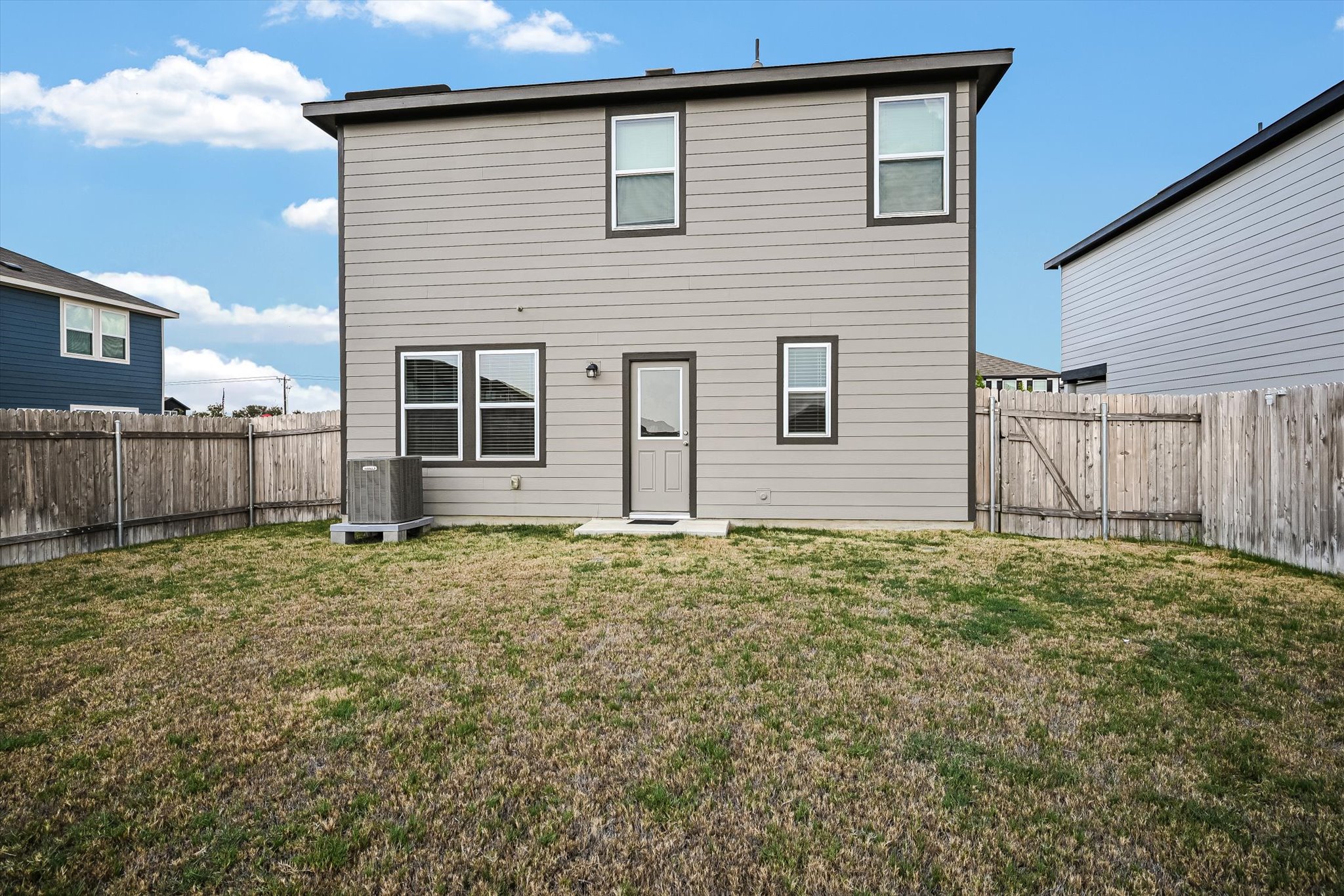 18213 Stellers Sea Street Elgin, TX 78621 - Photo 19 of 20 A spacious level yard is enclosed by a privacy fence behind the two-story home.