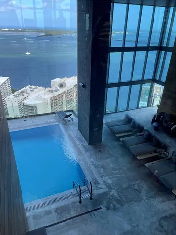 a living room with furniture city view and large windows