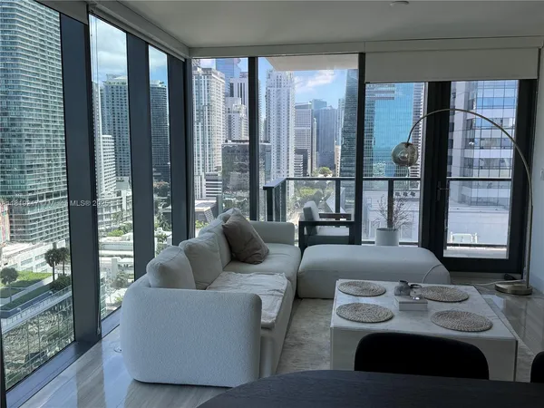 a bedroom with furniture and large windows