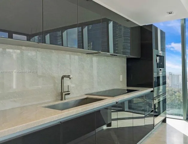 a kitchen with a sink and refrigerator