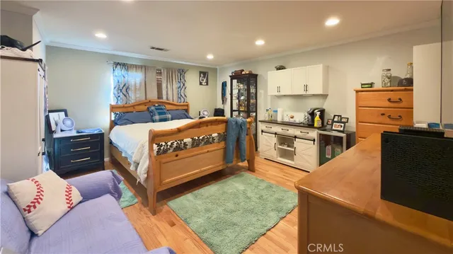 a bedroom with a bed and a dresser