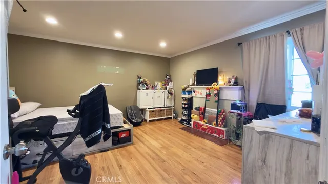 a living room with furniture a flat screen tv and a large window