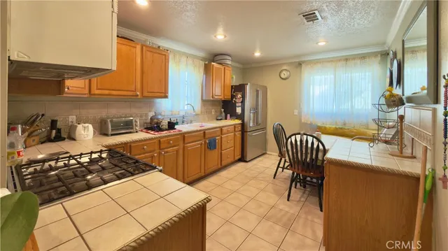 a kitchen with a sink a stove and chairs