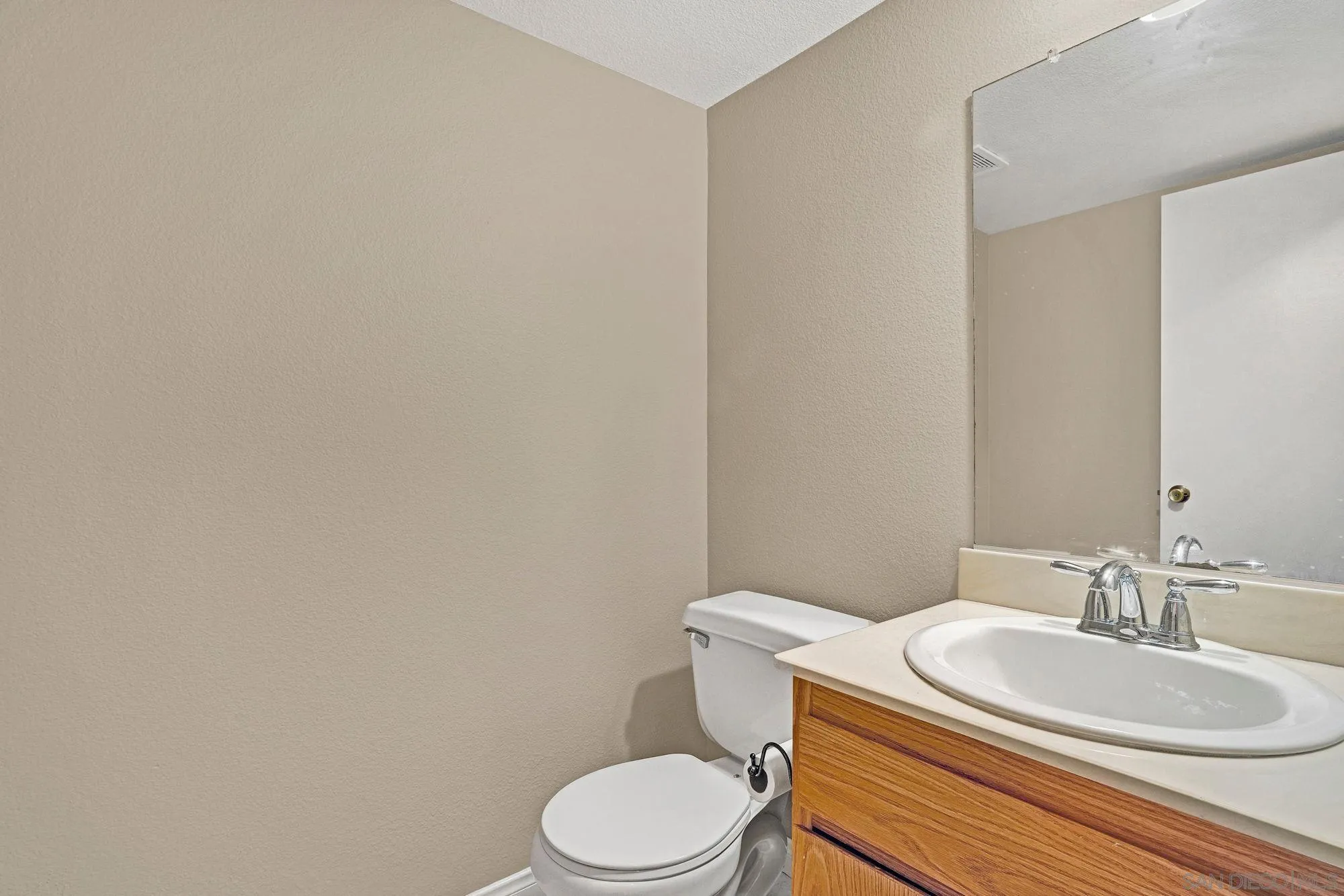 13644 Mulberry Tree Court Poway, CA 92064 - Photo 17 of 37 a white toilet sitting next to a bathroom sink
