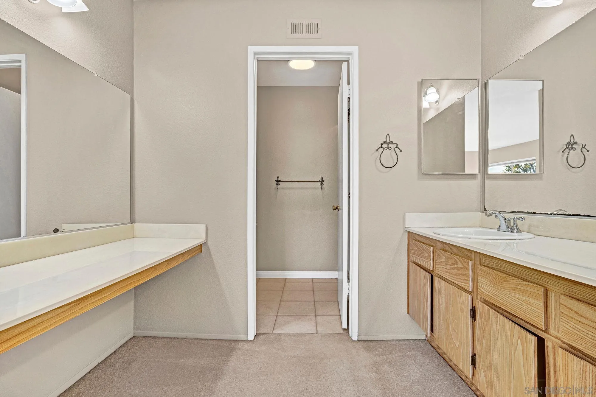 13644 Mulberry Tree Court Poway, CA 92064 - Photo 19 of 37 a bathroom with a sink and a mirror
