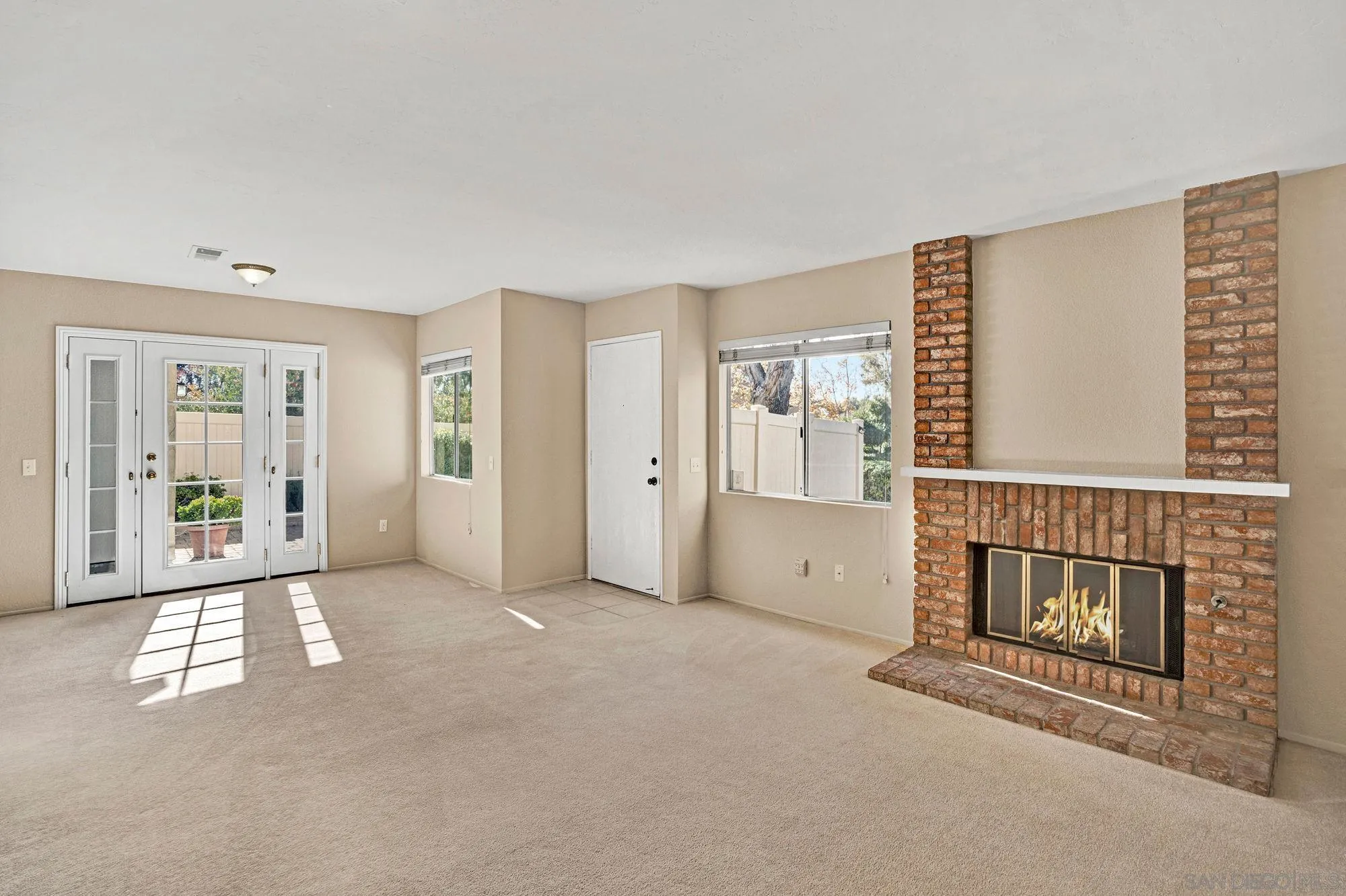 13644 Mulberry Tree Court Poway, CA 92064 - Photo 4 of 37 an empty room with fireplace and windows