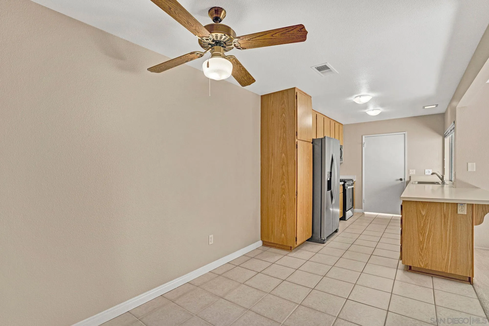 13644 Mulberry Tree Court Poway, CA 92064 - Photo 10 of 37 a view of a kitchen with a sink and a refrigerator