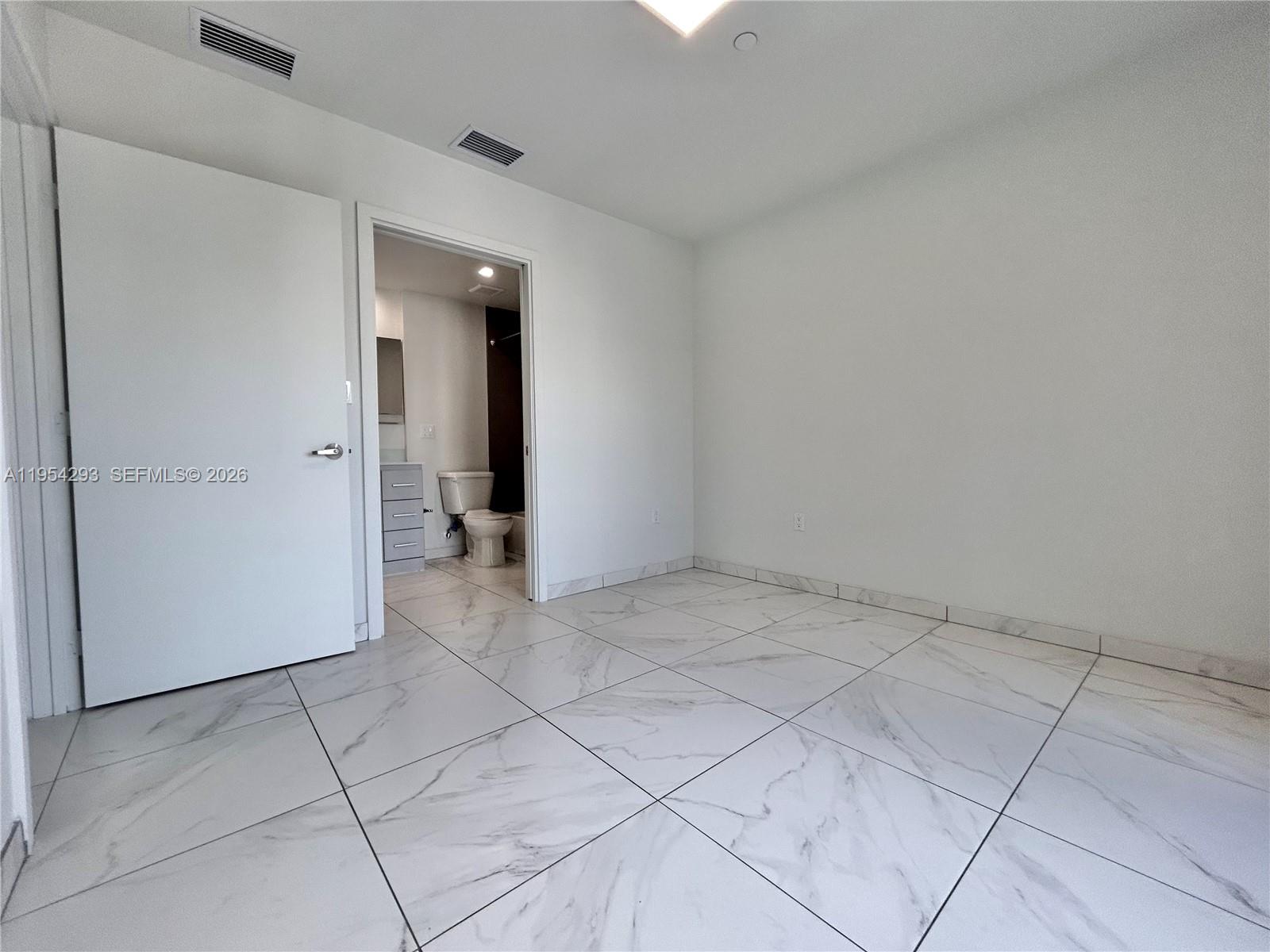 836 Southwest 2nd Street, Unit 202 Miami, FL 33130 - Photo 17 of 36 an empty room with a bathroom