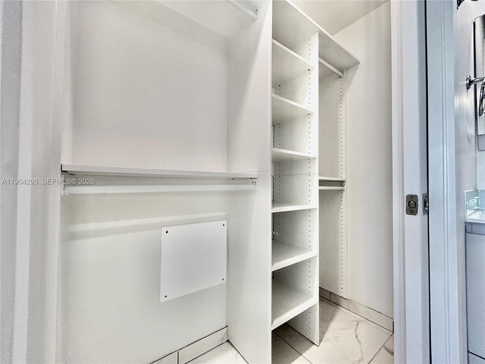 836 Southwest 2nd Street, Unit 202 Miami, FL 33130 - Photo 21 of 36 a view of walk in closet with empty racks