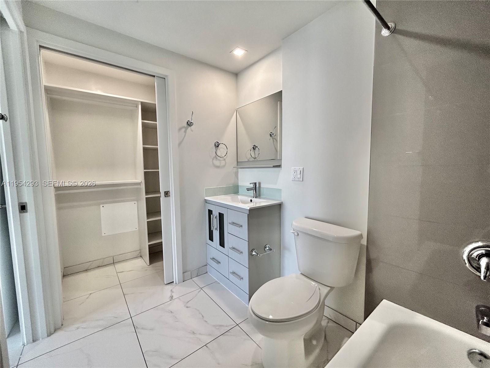 836 Southwest 2nd Street, Unit 202 Miami, FL 33130 - Photo 23 of 36 a bathroom with a sink toilet and shower