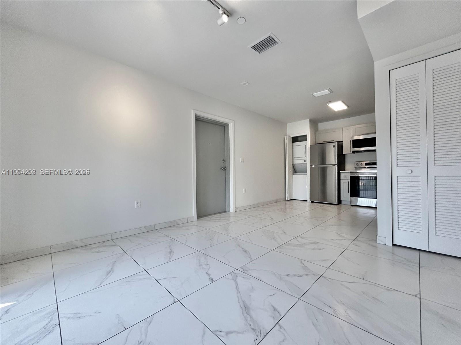 836 Southwest 2nd Street, Unit 202 Miami, FL 33130 - Photo 7 of 36 a view of an empty room and a kitchen