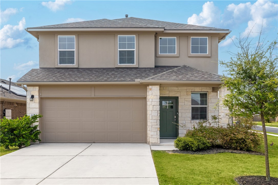 a front view of a house with a yard