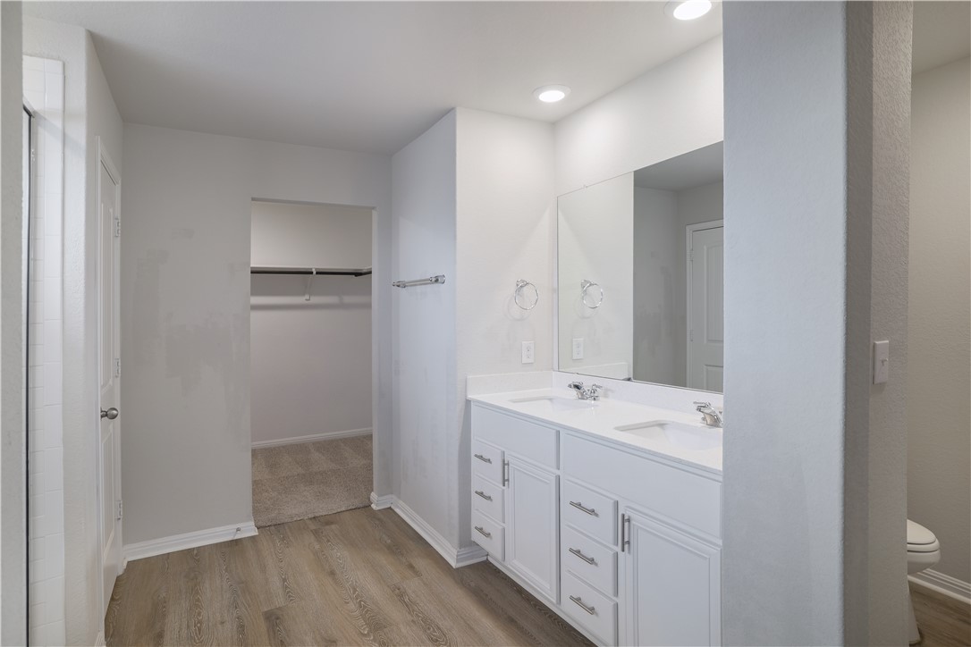 445 Shiner Lane Georgetown, TX 78626 - Photo 25 of 35 a spacious bathroom with a double vanity sink a mirror and a shower