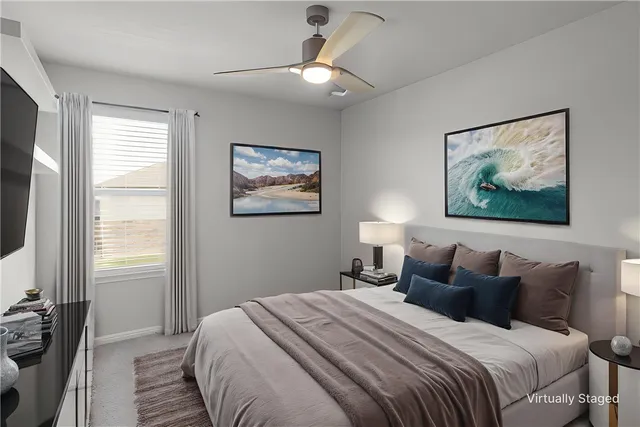 a bedroom with bed painting on the wall and a window