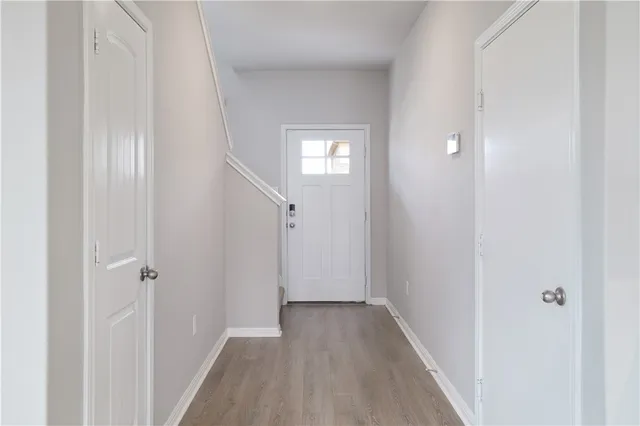 a view of a hallway with wooden floor
