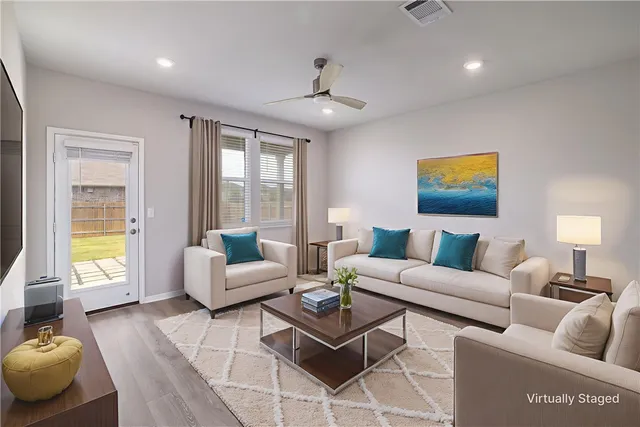 a living room with furniture and a large window