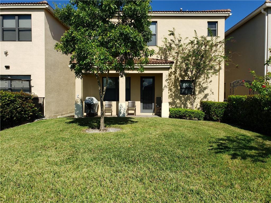 Undisclosed Address Miami, FL 33179 - Photo 17 of 24 a backyard of a house with table and chairs and potted plants