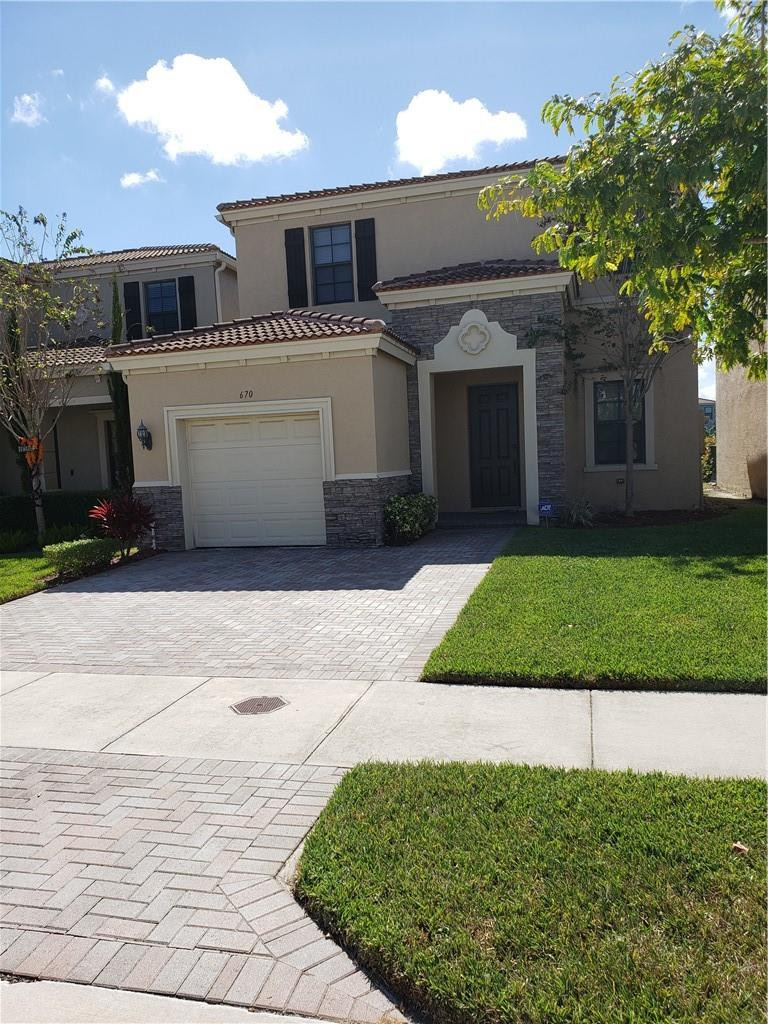 Undisclosed Address Miami, FL 33179 - Photo 3 of 24 a front view of a house with a yard and garage