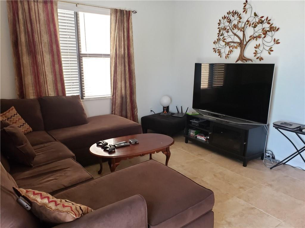 Undisclosed Address Miami, FL 33179 - Photo 6 of 24 a living room with furniture a flat screen tv and a window