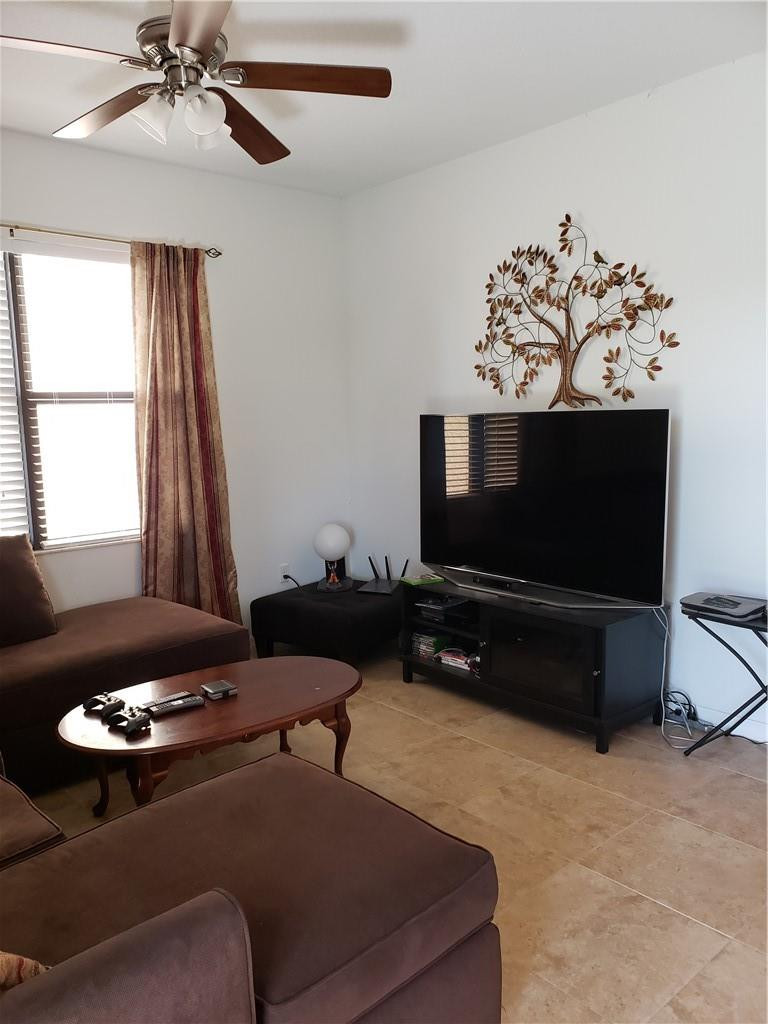 Undisclosed Address Miami, FL 33179 - Photo 7 of 24 a living room with furniture and a flat screen tv