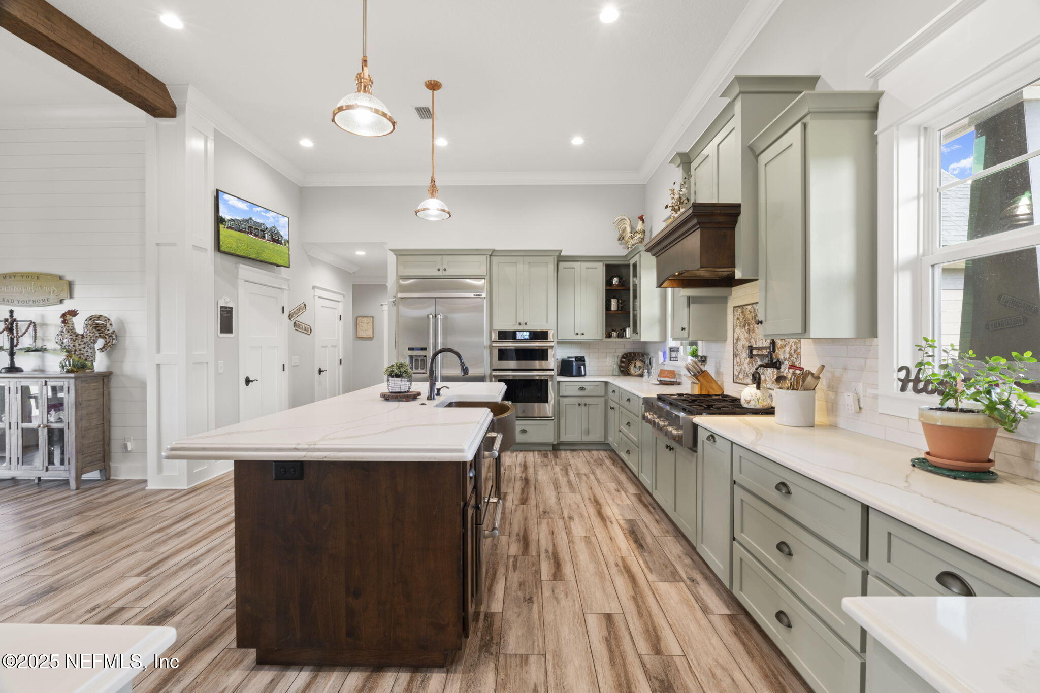 54515 Wildlife Way Callahan, FL 32011 - Photo 18 of 90 a large kitchen with stainless steel appliances kitchen island granite countertop a lot of counter space and a sink