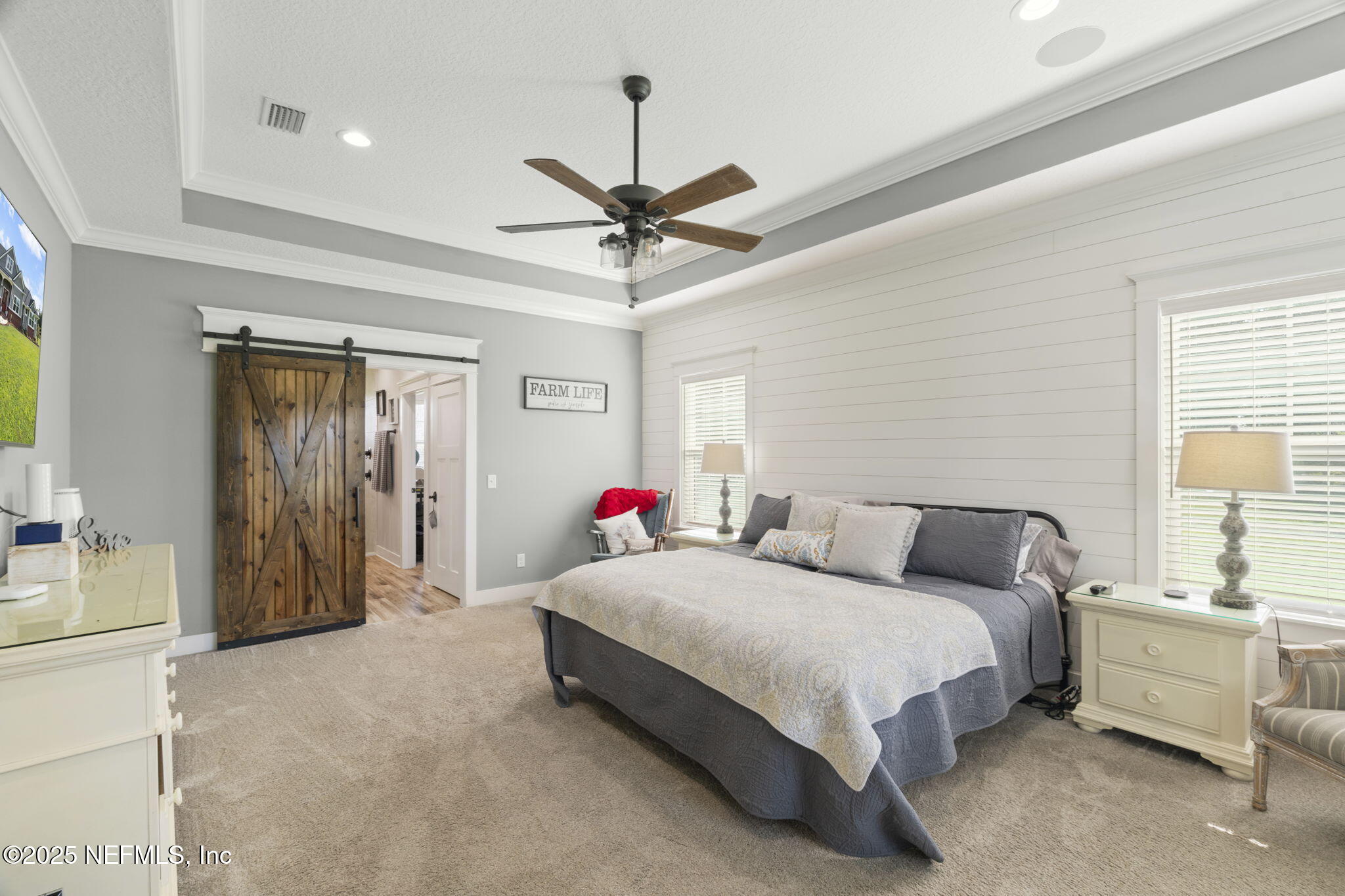 54515 Wildlife Way Callahan, FL 32011 - Photo 30 of 90 a spacious bedroom with a bed and a chandelier