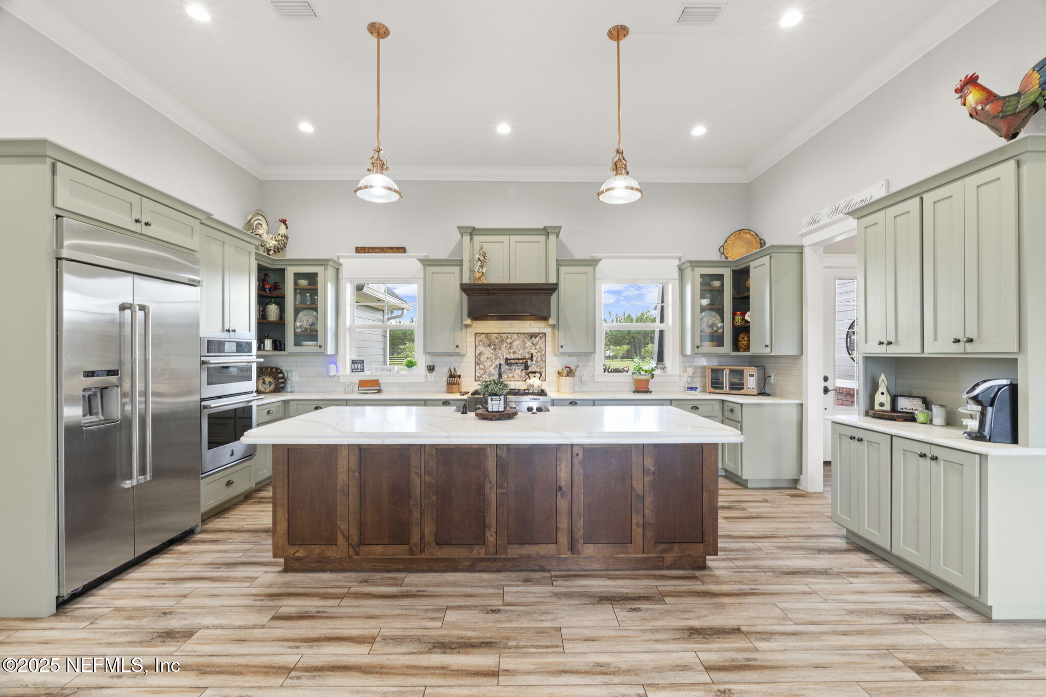 54515 Wildlife Way Callahan, FL 32011 - Photo 3 of 90 a large kitchen with kitchen island a large counter top stainless steel appliances and cabinets
