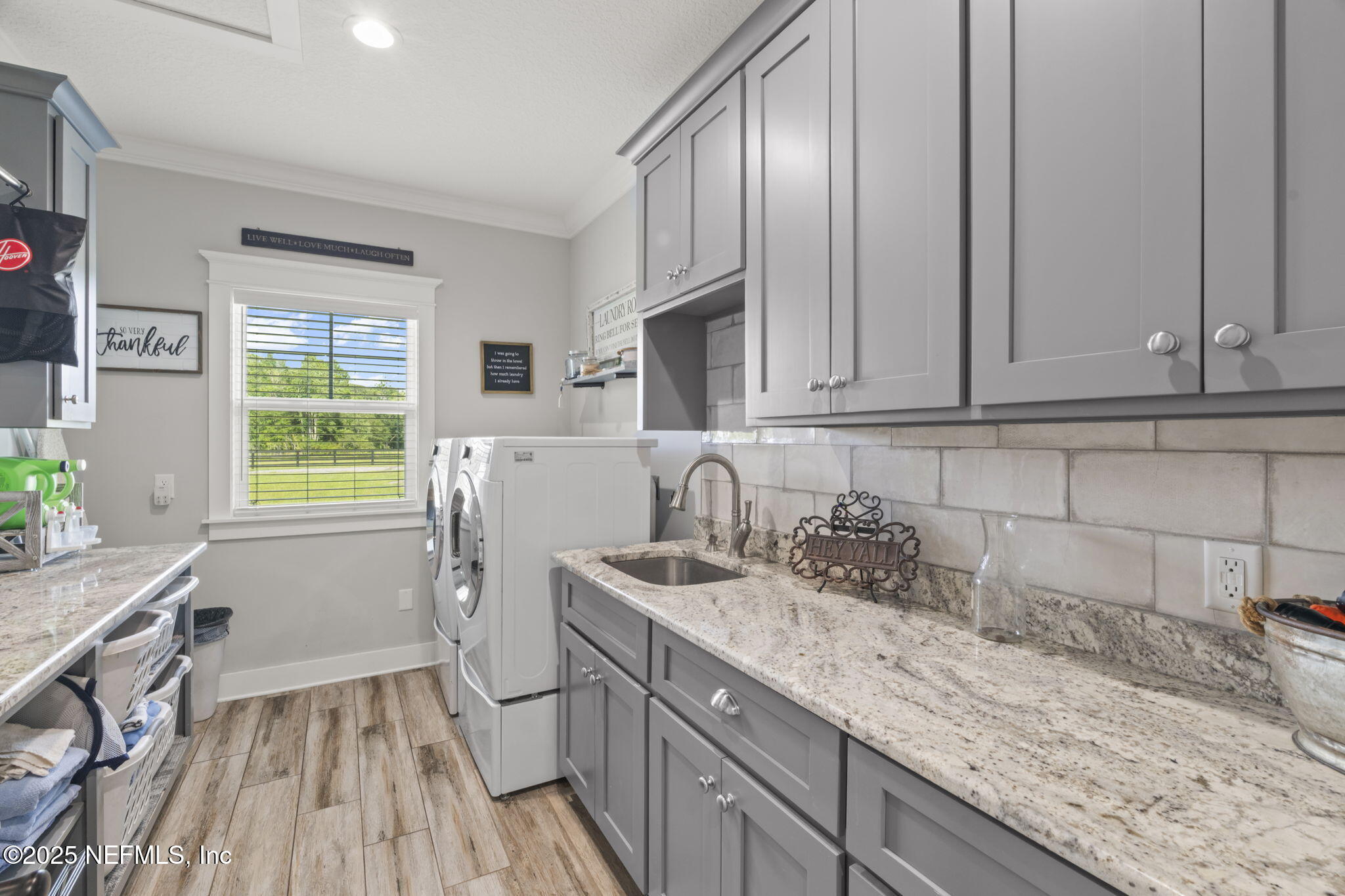 54515 Wildlife Way Callahan, FL 32011 - Photo 45 of 90 a kitchen with a sink a stove cabinets and a wooden floor