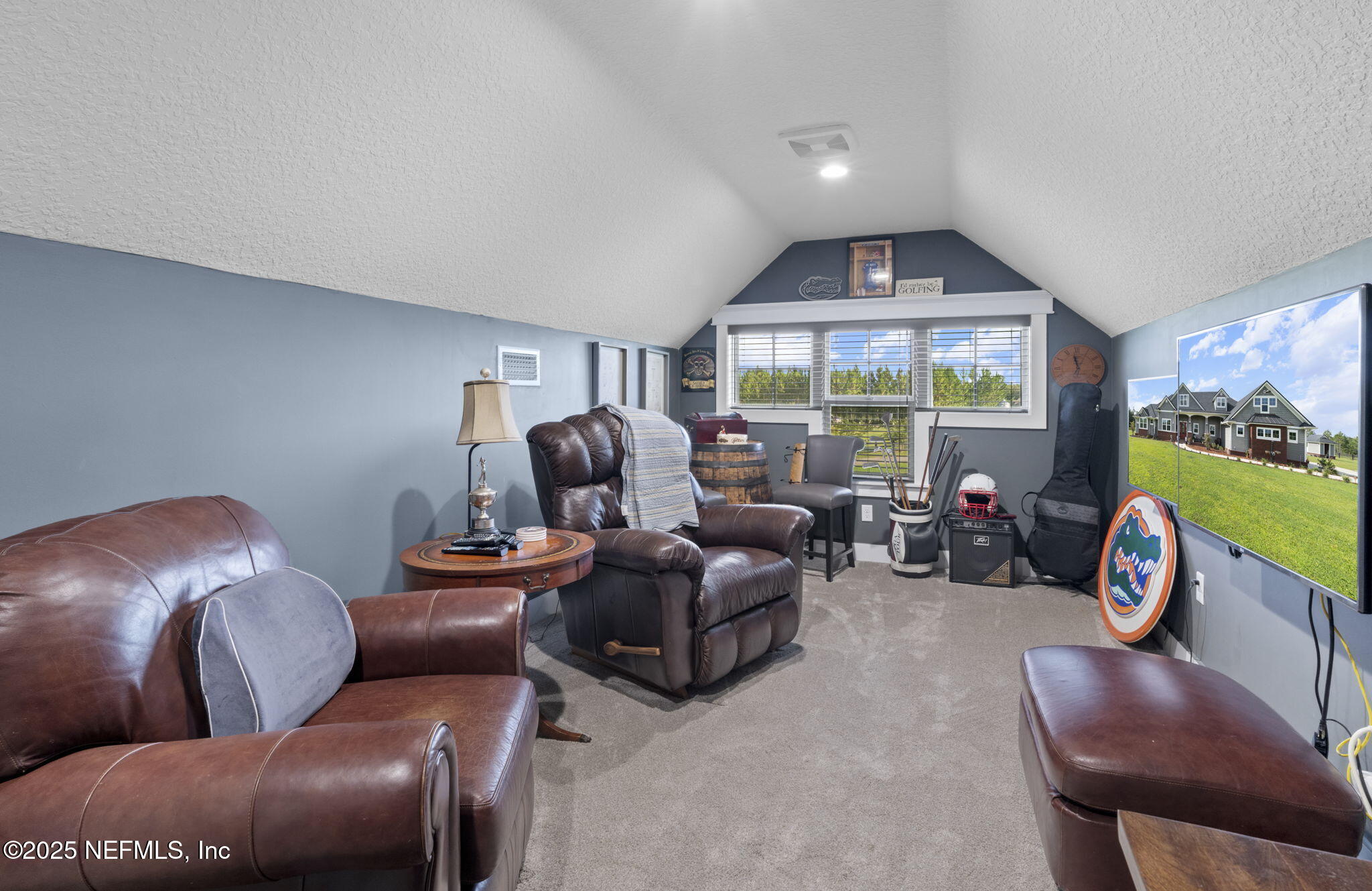 54515 Wildlife Way Callahan, FL 32011 - Photo 48 of 90 a living room with furniture and a flat screen tv