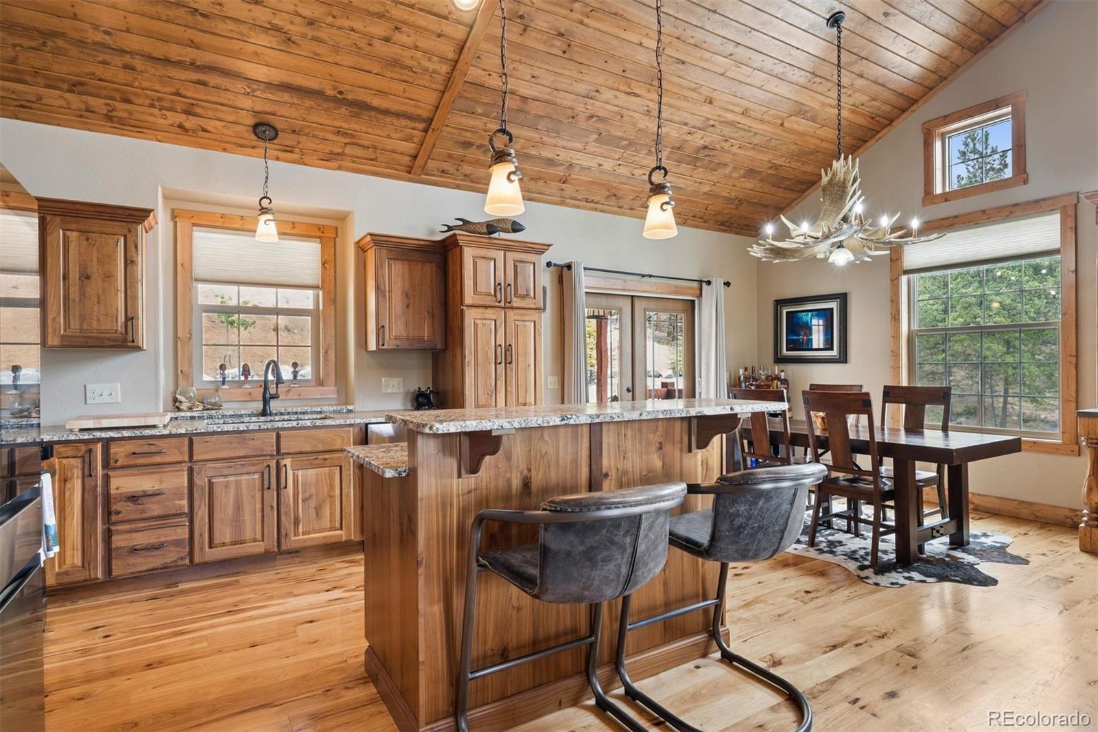 2894 County Road 43 Bailey, CO 80421 - Photo 11 of 40 a view of a dining room with furniture window and wooden floor