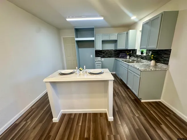 a kitchen with a sink appliances and cabinets