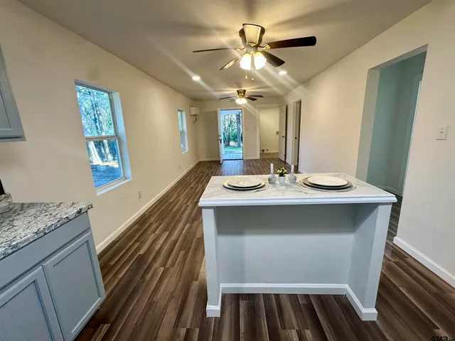 a bathroom with a sink a large mirror and vanity