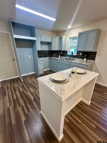 a kitchen with a sink a stove and cabinets