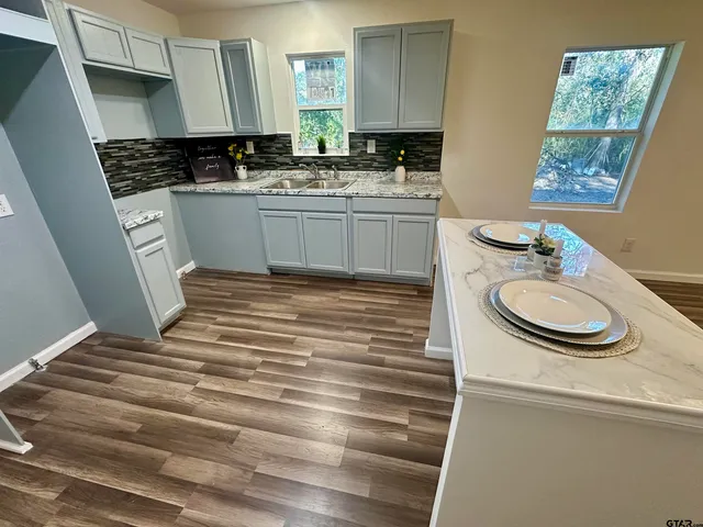 a kitchen with a sink and a stove