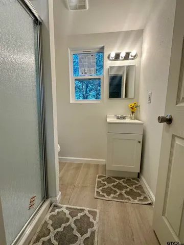a bathroom with a sink toilet and shower